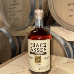 Barrel Aged Rum in front of barrels